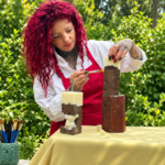 Gabriela Șorică pictează manual o lumânare decorativă realizată pentru Soul Light Atelier.